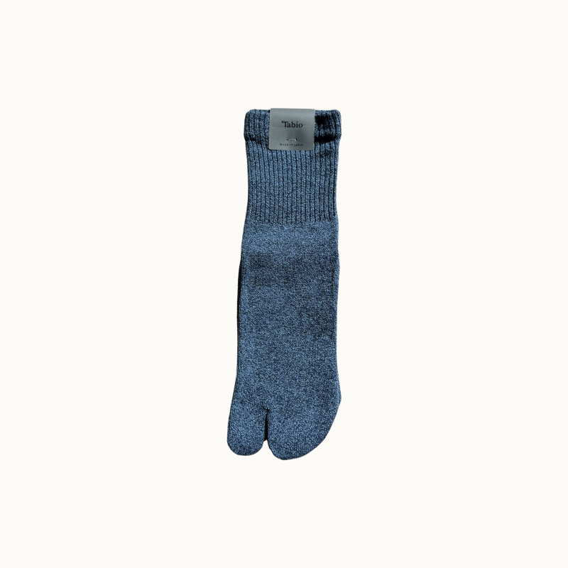 Blue tabi sock with a visible brand label on a white background