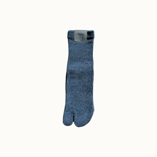 Blue tabi sock with a visible brand label on a white background